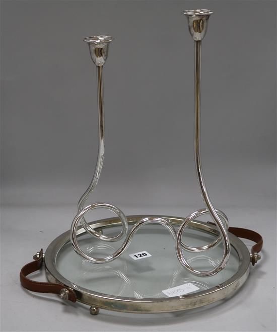 A silver candelabra and a silver glass chrome and leather strapped tray